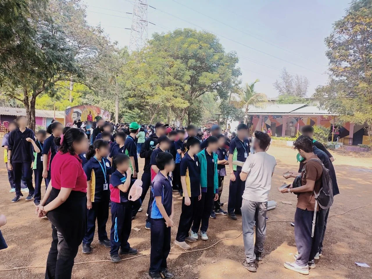 Students gathered outdoors at a TABIS event, faces blurred
